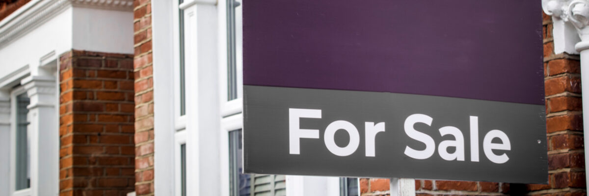 Purple for sale sign outside a home