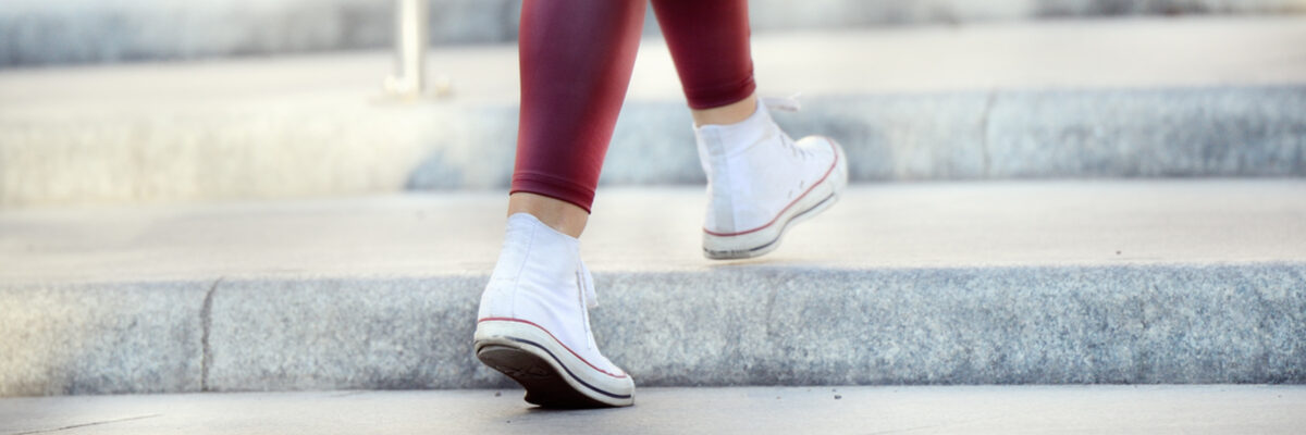 Close up of woman walking up stairs